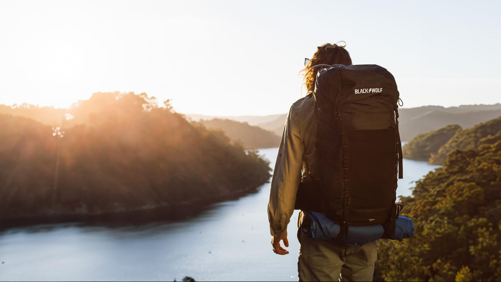 Hiker overlooking gorge, with BlackWolf backpack