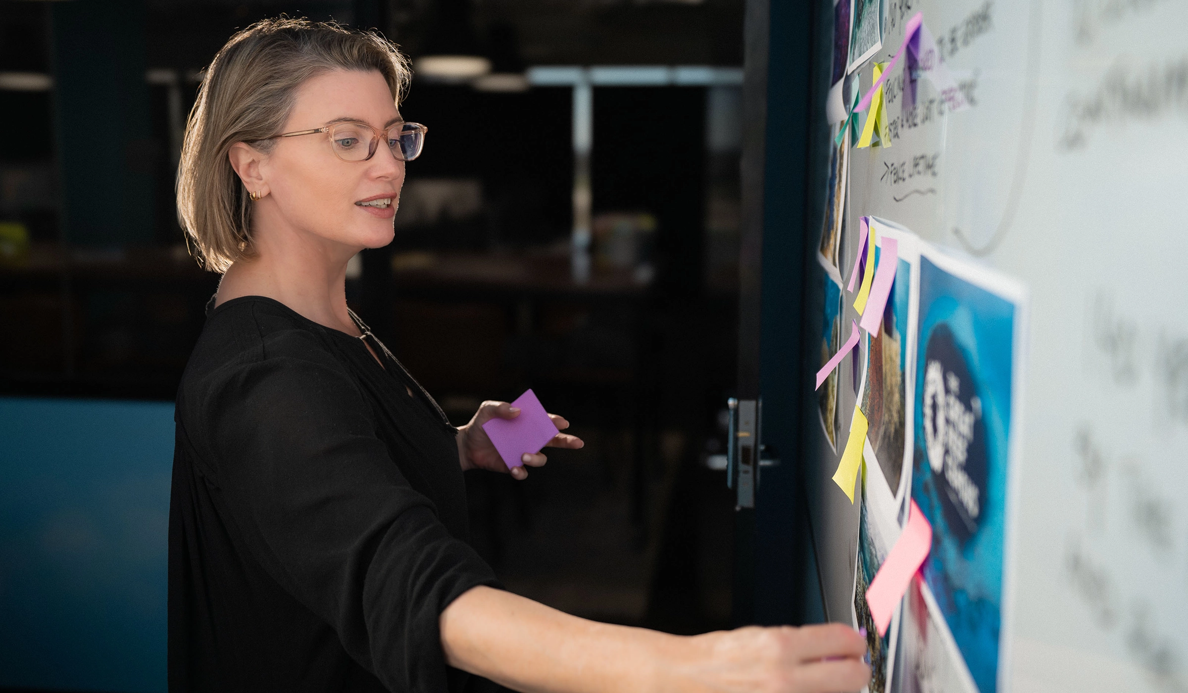 Creative Director using post-it notes on white board
